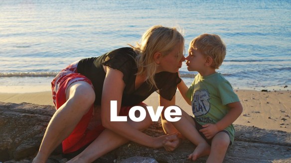 Child and adult on beach